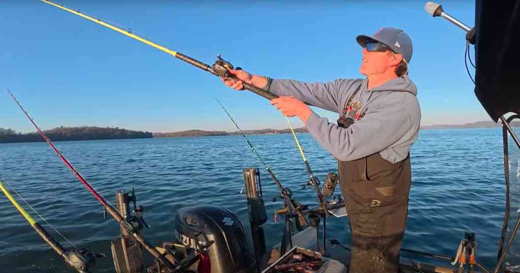 Spencer Bauer of River Certified casts a bright-yellow Hellcat rod over a chilly blue lake.
